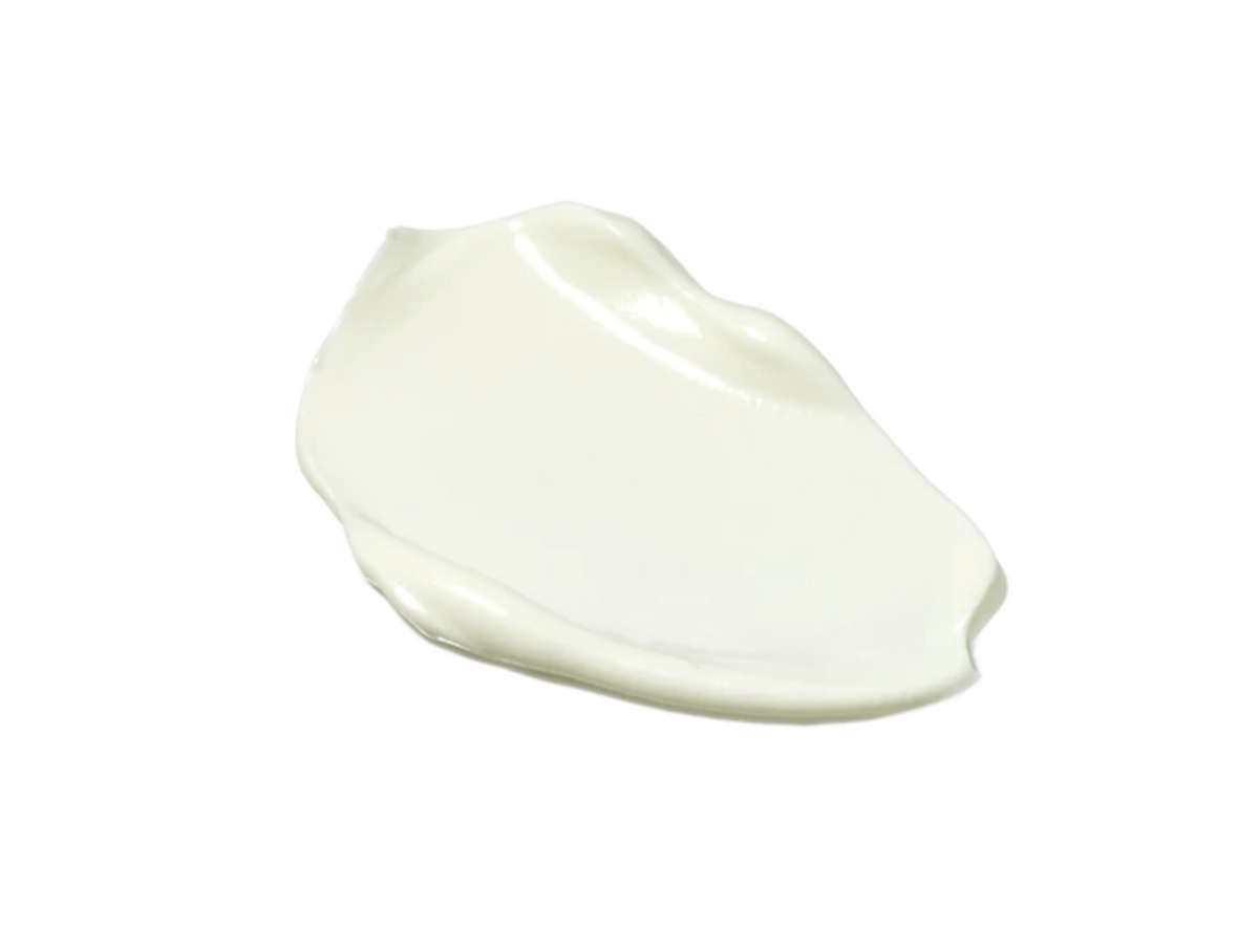 A dollop of thick, creamy off-white cosmetic product, shown on a solid white background.