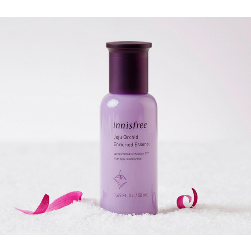 A bottle of Innisfree Jeju Orchid Enriched Essence, an anti-aging facial essence for a healthy glow and improved firmness.