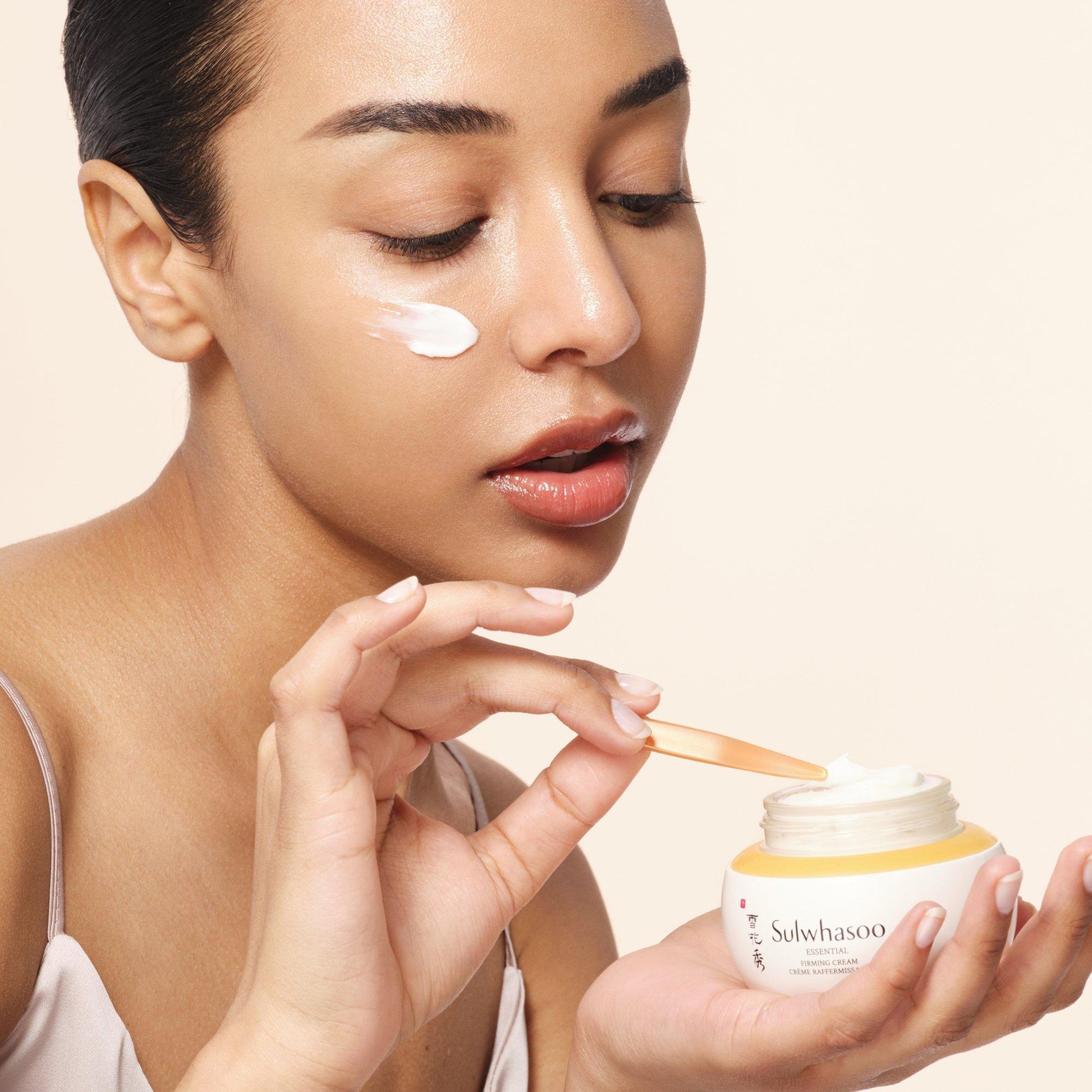 A 75ml jar of Sulwhasoo Essential Comfort Firming Cream, a skincare product for anti-aging and firming.