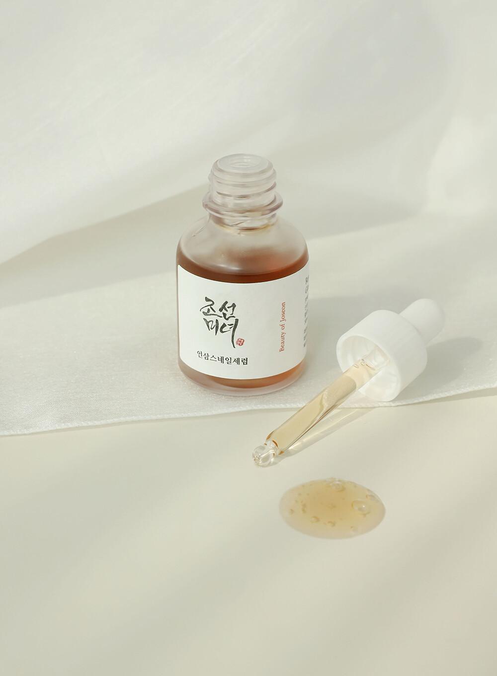 Beauty Of Joseon Revive Serum on a white surface with some of the serum on the table