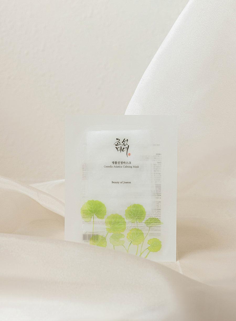 Beauty of Joseon Centella Asiatica Calming Mask, a single-use facial masks to soothe and moisturize skin against a white flowy backdrop