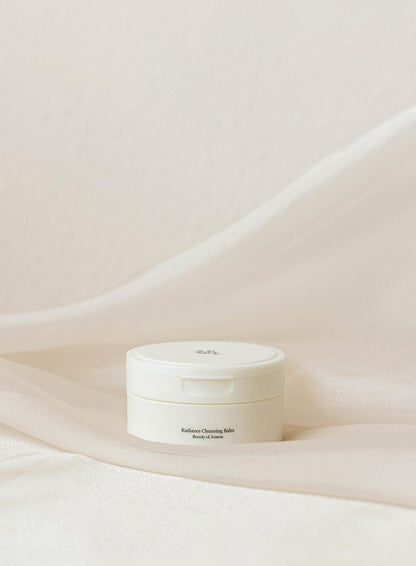 100ml tub of Beauty of Joseon Radiance Cleansing Balm, a sherbet-like balm that melts away makeup and impurities against a white flowy backdrop