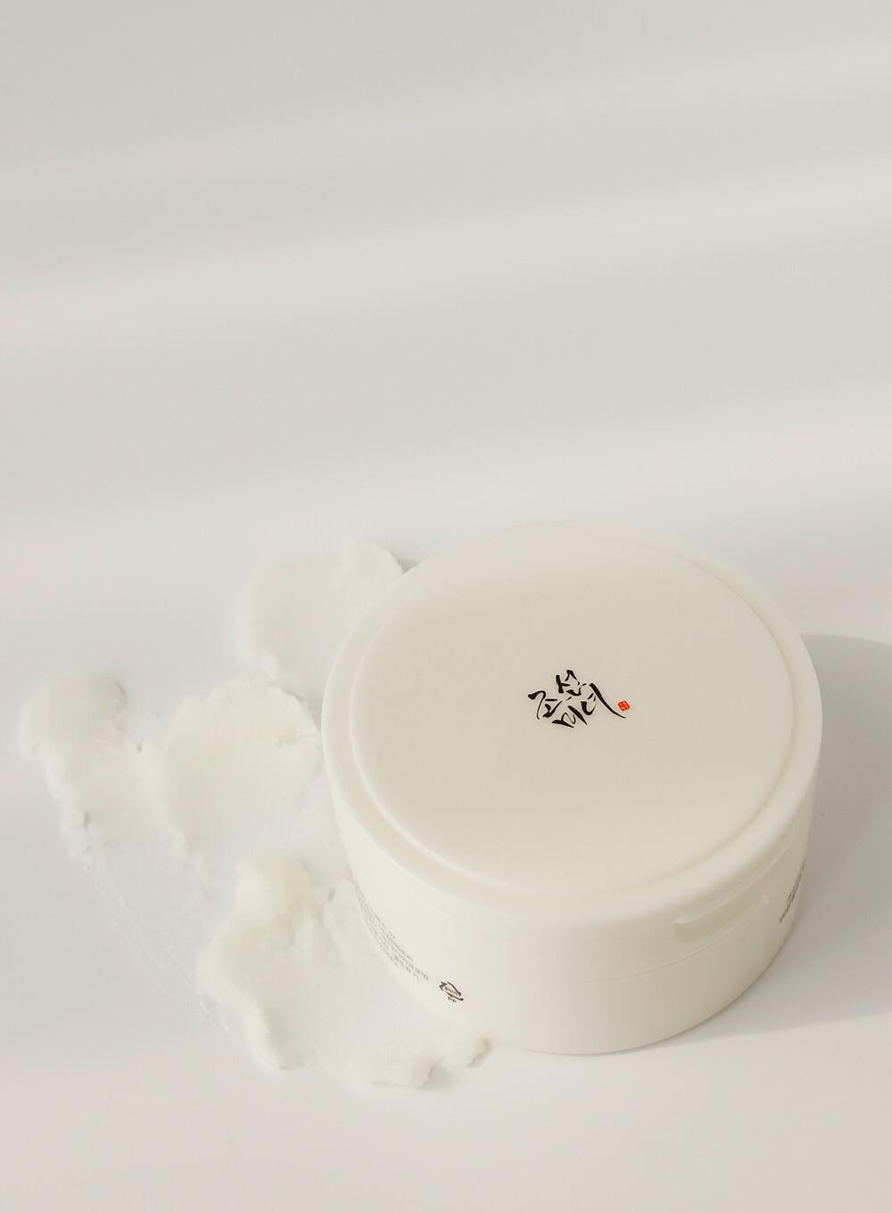 100ml tub of Beauty of Joseon Radiance Cleansing Balm, some of the sherbet-like balm on the white surface