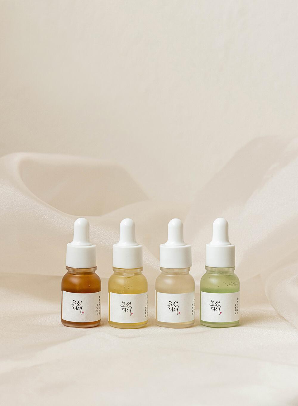 Beauty of Joseon Hanbang Serum Discovery Kit, featuring four 10ml travel-sized serums for calming, brightening, anti-acne, and rejuvenation against a white flowy backdrop