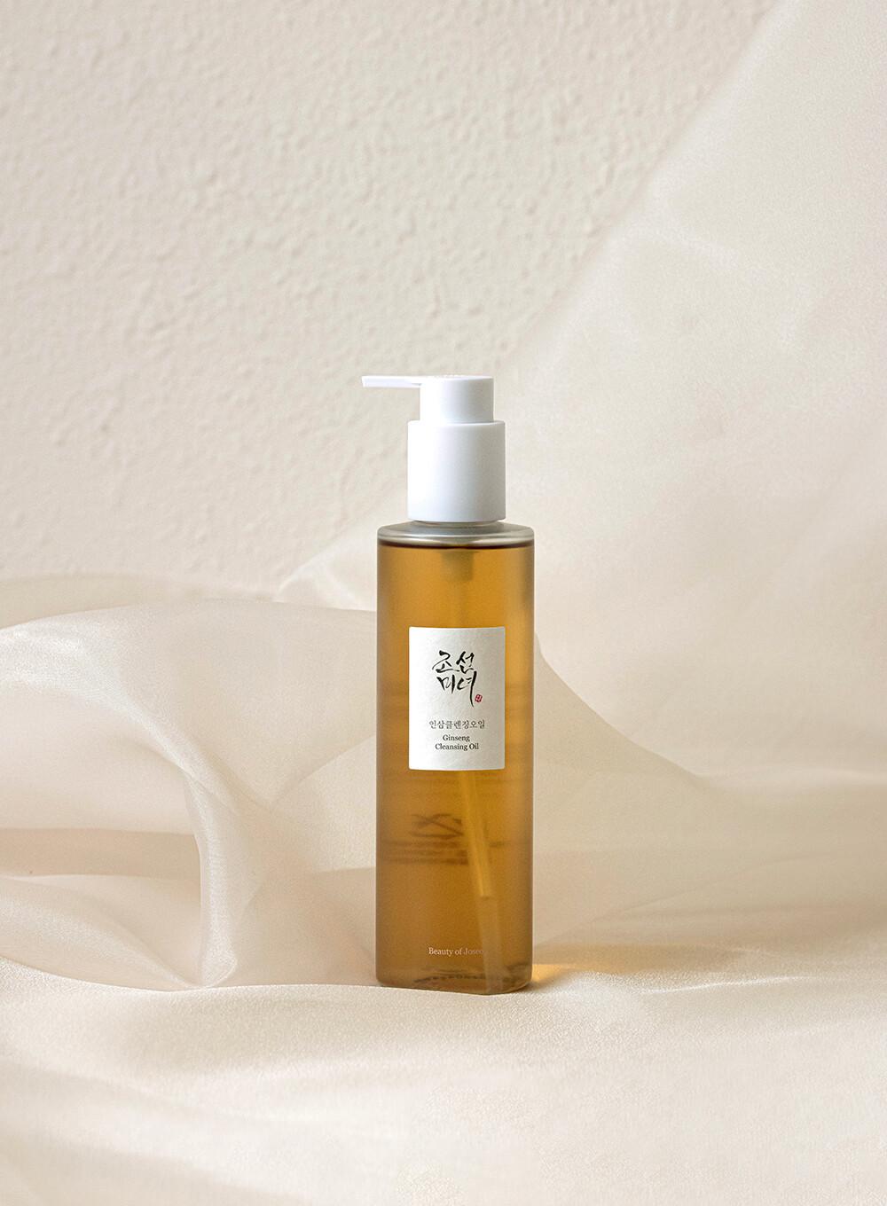 210ml bottle of Beauty of Joseon Ginseng Cleansing Oil, a Korean skincare oil cleanser for dissolving makeup and impurities against a white flowy backdrop