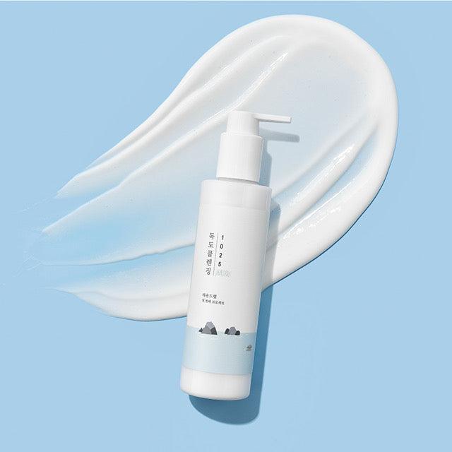 White bottle with pump dispenser of Roundlab 1025 Dokdo Cleansing Milk, a gentle facial cleanser for sensitive skin.