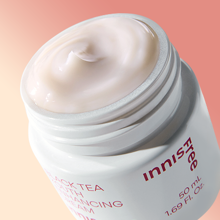 A 50ml jar of Innisfree Youth Enhancing Cream, a hydrating anti-aging cream formulated with black tea extract.