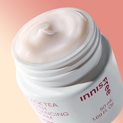 A 50ml jar of Innisfree Youth Enhancing Cream, a hydrating anti-aging cream formulated with black tea extract.