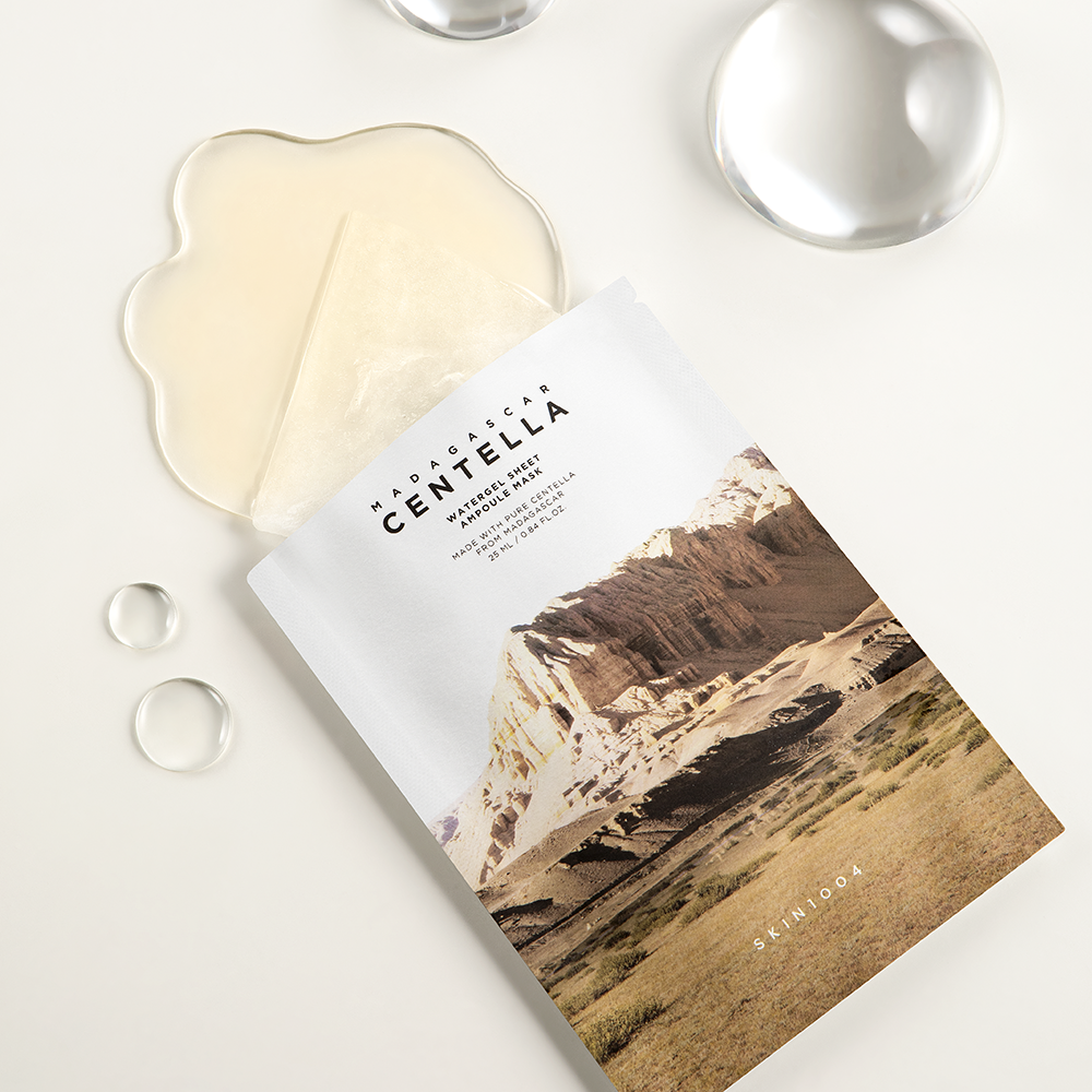 Brown colored, watergel sheet masks containing Centella Asiatica extract and corn mint oil to soothe and moisturize skin.