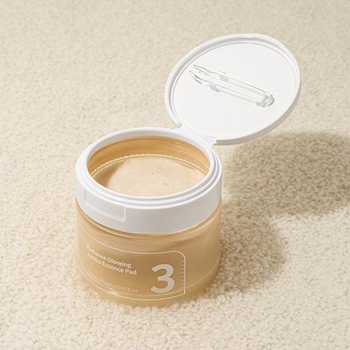 A jar of Numbuzin No. 3 Radiance Glowing Jumbo Essence Pads, containing 70 pre-soaked pads in 150ml of essence for brightening and hydrating skin.