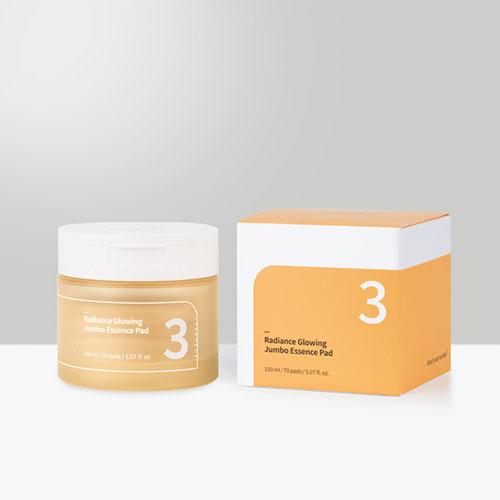 A jar of Numbuzin No. 3 Radiance Glowing Jumbo Essence Pads, containing 70 pre-soaked pads in 150ml of essence for brightening and hydrating skin.