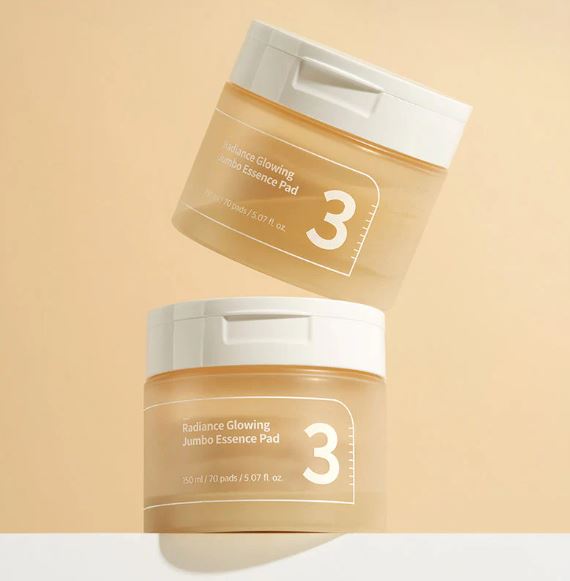 A jar of Numbuzin No. 3 Radiance Glowing Jumbo Essence Pads, containing 70 pre-soaked pads in 150ml of essence for brightening and hydrating skin.