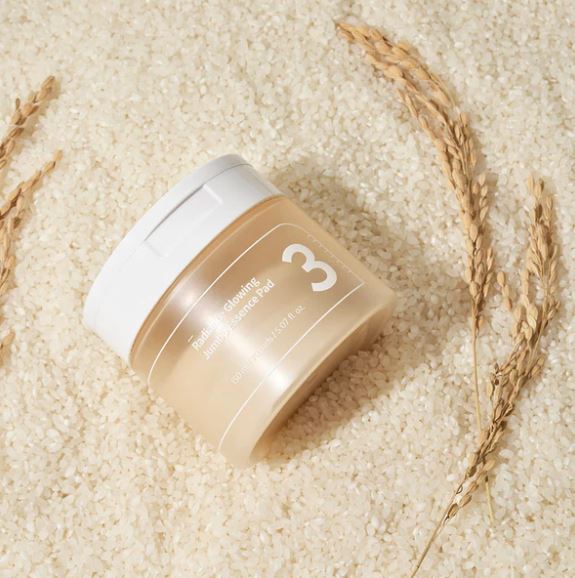 A jar of Numbuzin No. 3 Radiance Glowing Jumbo Essence Pads, containing 70 pre-soaked pads in 150ml of essence for brightening and hydrating skin.