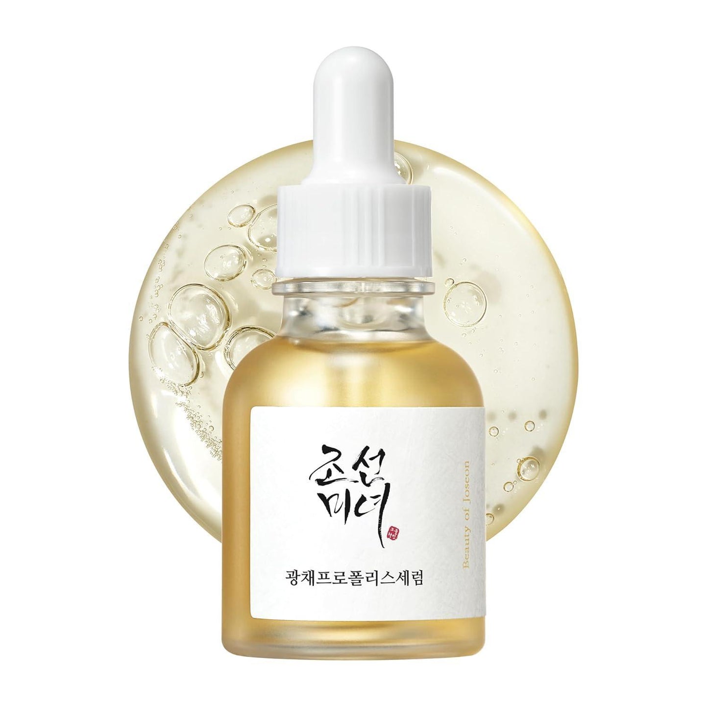 30ml bottle of Beauty of Joseon Glow Serum, a Korean skincare serum with propolis and niacinamide for radiant and balanced skin up against a white flowy backdrop