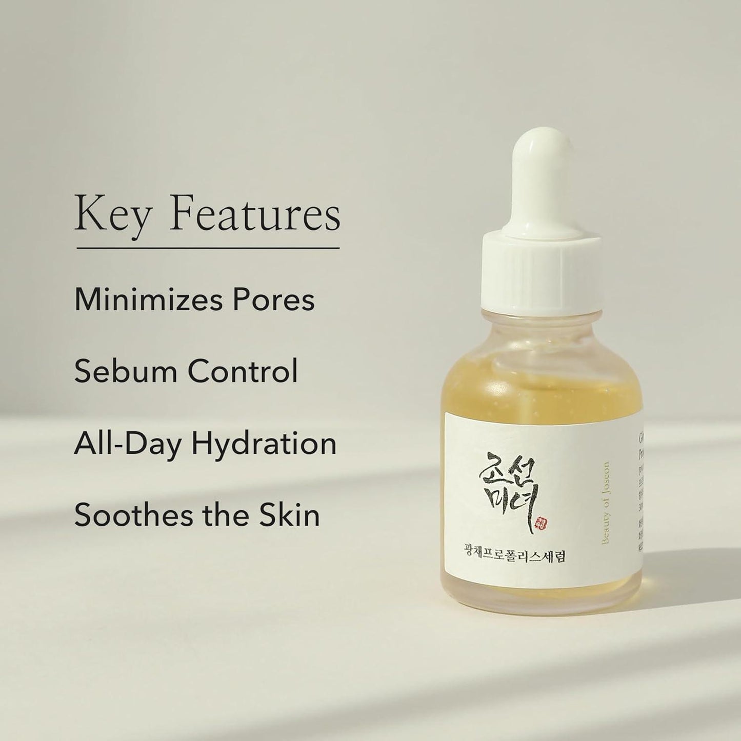 30ml bottle of Beauty of Joseon Glow Serum, a Korean skincare serum with propolis and niacinamide for radiant and balanced skin up against a white flowy backdrop