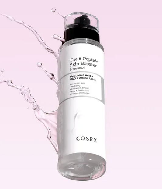 COSRX The 6 Peptide Skin Booster serum in a clear cylindrical bottle with a white label and black pump, shown floating against a soft pink background with water splash graphics.