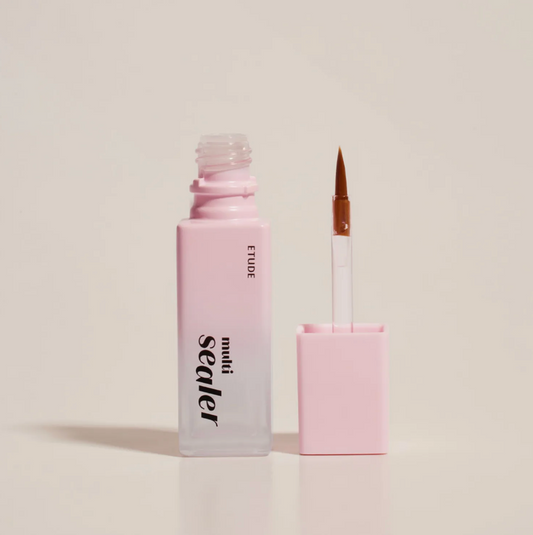 A bottle of ETUDE Sealer liquid with a pink-to-clear gradient and a separate applicator brush with a pink cap, set against a solid light beige background.