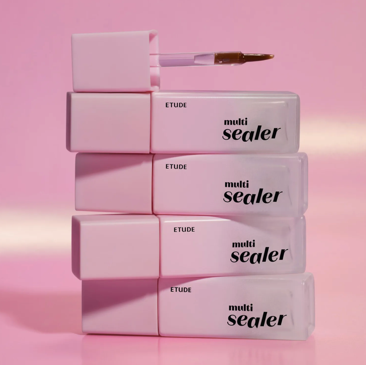 Four ETUDE multi sealer tubes stacked vertically on a pink background, with the top tube open and its applicator brush resting above it.