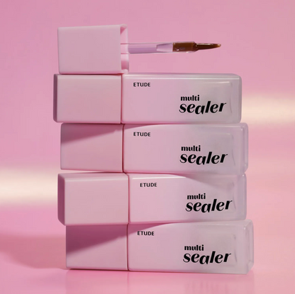 Four ETUDE multi sealer tubes stacked vertically on a pink background, with the top tube open and its applicator brush resting above it.