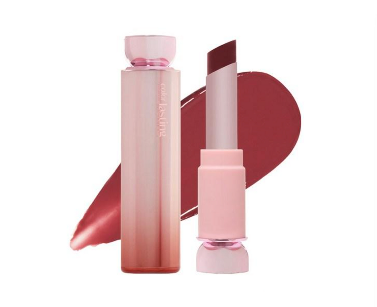 A pink cosmetic lipstick tube and matching cap shown beside an open lipstick bullet with a deep rosy red shade, set against a white background with a large lipstick smear behind them. The tube has vertical text reading 'melt by ASVEL'.