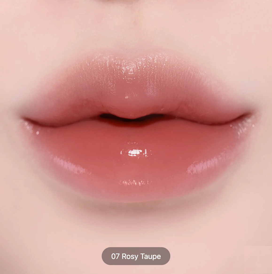 Close-up of glossy lips wearing a rosy taupe lip color, with a small label at the bottom reading '07 Rosy Taupe'.