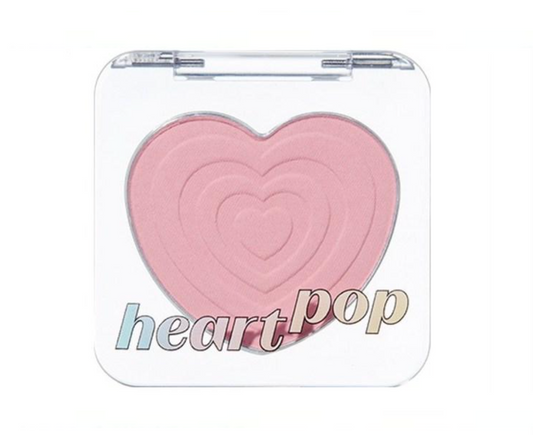 A heart-shaped blush compact with a clear plastic case and the words 'heart pop' printed on the front, set against a plain white background.