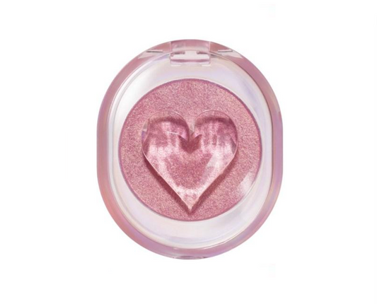 A single-pan eyeshadow compact with a translucent pink lid and a heart-shaped embossed shadow in a shimmering pink shade, shown on a plain white background.