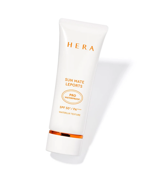 A white squeeze tube of HERA Sun Mate Leports sunscreen with gold text and a gold accent band near the cap, shown on a clean white background with a soft shadow.