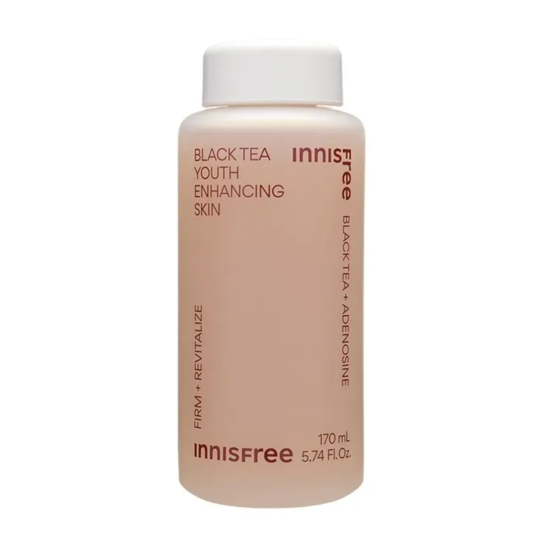 An Innisfree skincare bottle containing Black Tea Youth Enhancing Skin serum, featuring a pale peach-pink liquid and a white cap on a clean white background.