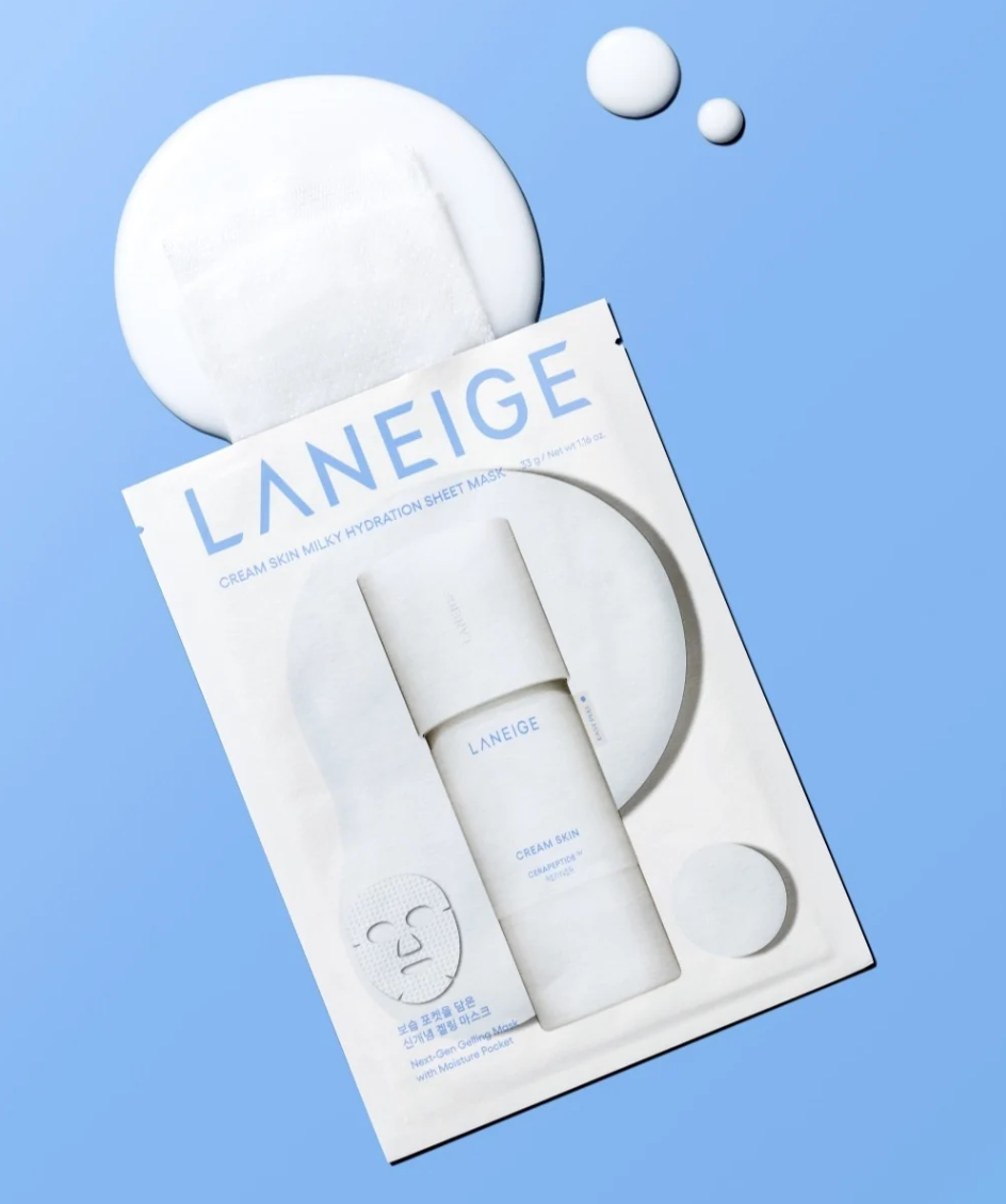 LANEIGE Cream Skin Hydration Sheet Mask in a white single-use pouch, shown with two white round sheet masks and a white Laneige cream bottle on a light blue background.