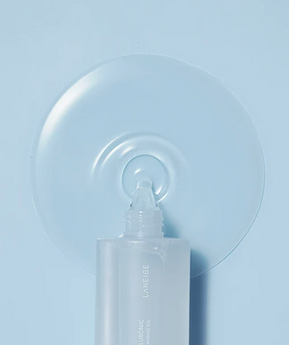 LANEIGE Water Bank Blue Hyaluronic Cleansing Oil in a frosted white squeeze bottle, shown dispensing clear oil in front of a large translucent droplet on a light blue background.