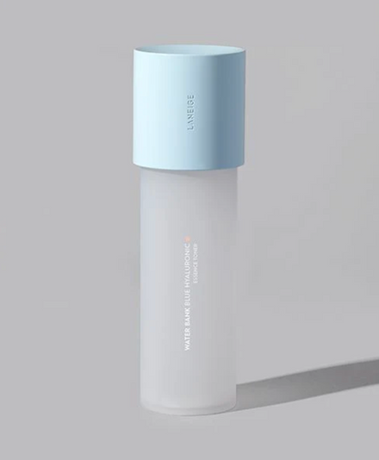 A frosted glass skincare bottle with a light blue cap, featuring vertical text that reads 'LANEIGE' and 'WATER BANK BLUE HYALURONIC ESSENCE TONER' on a neutral gray background.