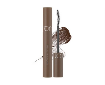A brown mascara tube shown next to its cap and spoolie wand on a white background, with a brown hair swatch graphic behind it.