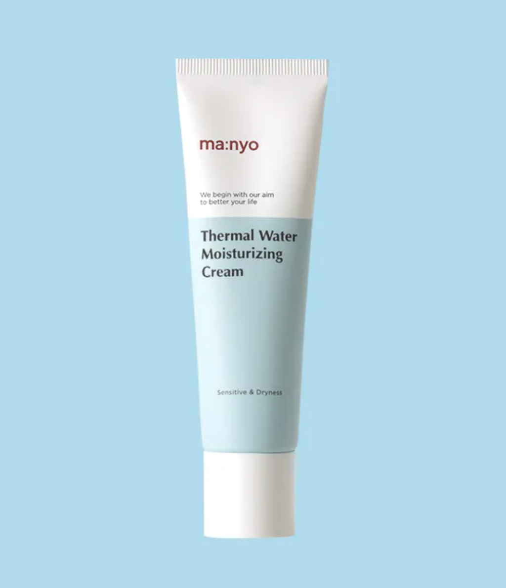 A single tube of ma:nyo Thermal Water Moisturizing Cream centered on a solid light blue background. The tube is white with a pale blue lower section and features the brand name 'ma:nyo' in red and the product name in black text.