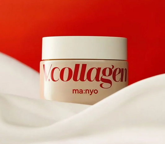 A cream-colored cosmetic jar with red text reading 'V.collagen' and 'ma:nyo' on the front, set against a bright red background with soft white fabric draped around the base.