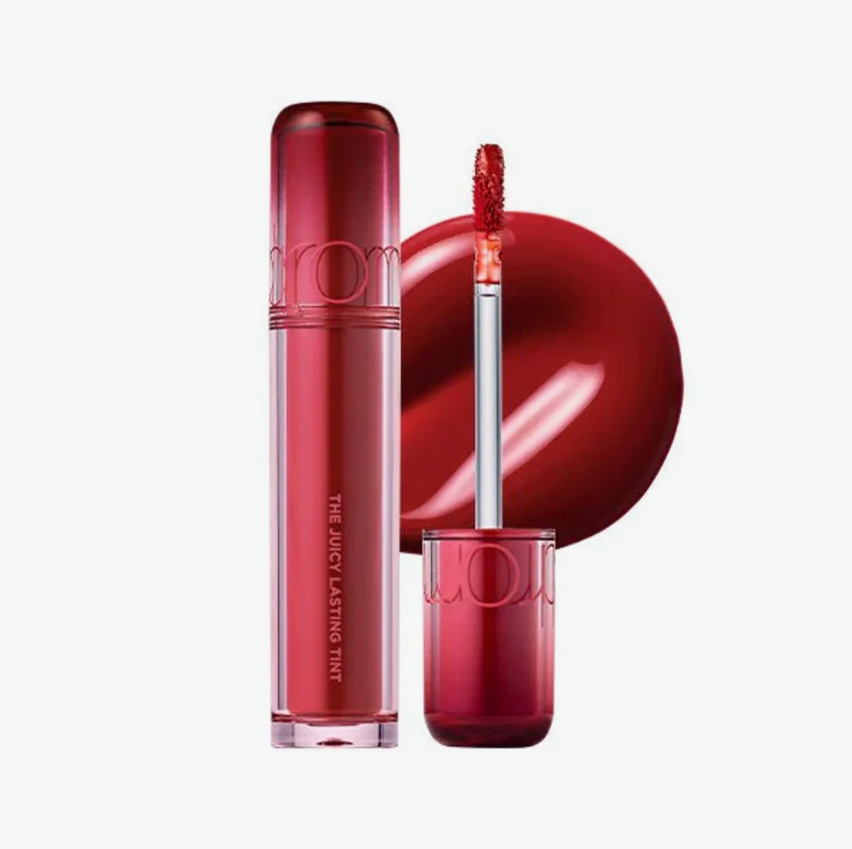 A liquid lipstick in a translucent deep red tube with a matching cap, shown alongside the applicator wand and a glossy red product swatch on a clean white background.