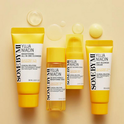 Travel-size kit containing SOME BY MI's Yuja Niacin skincare line for brightening and blemish reduction. Includes cleanser, toner, serum, and cream.